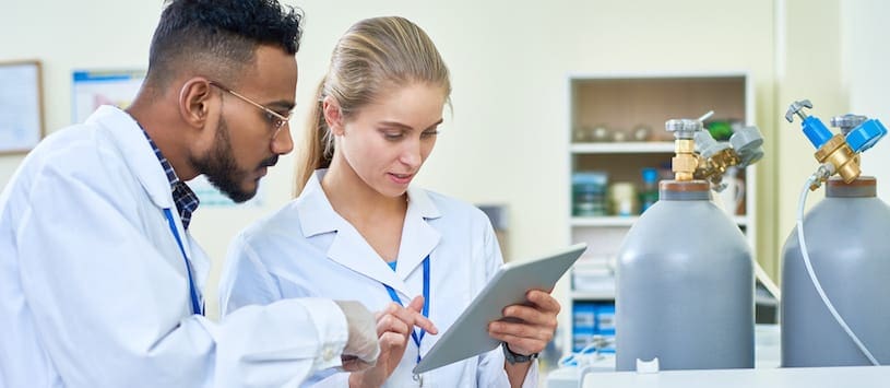 Two pharmacists looking at a tablet. For a great Pharmacy Technician Program come to NWSC.
